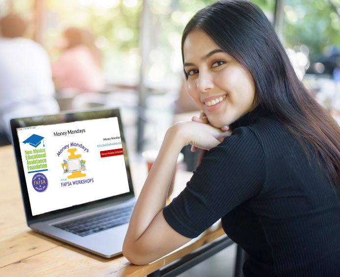 Young woman looking at a laptop screen smiling